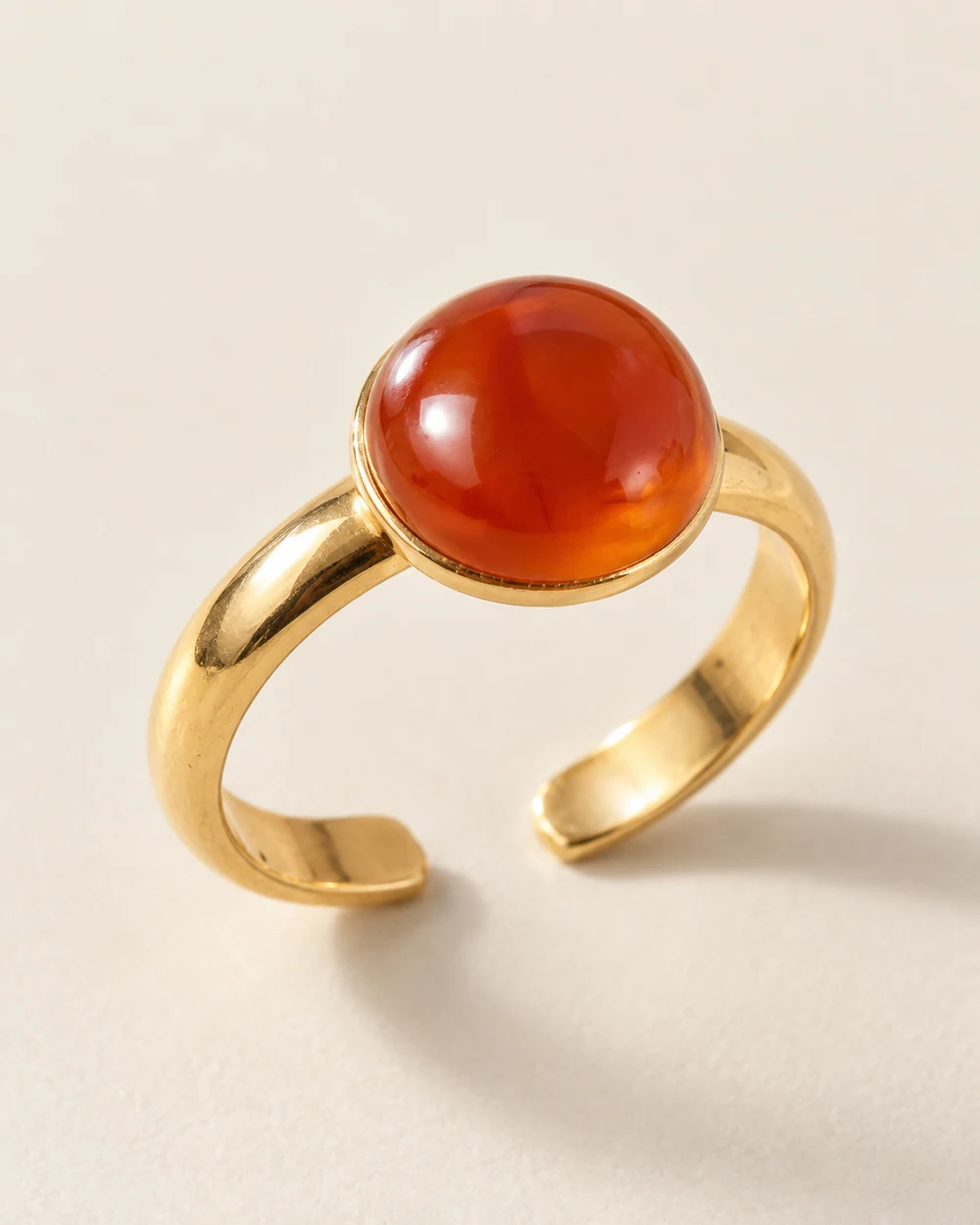 Terre — Cabochon cornaline 10 mm collé sur un demi-jonc réglable doré.